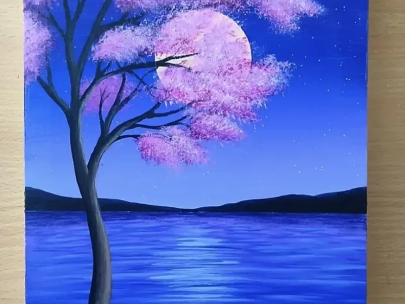 Hoa anh đào hồng bên hồ xanh đêm