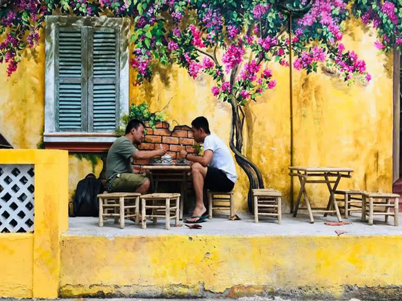 Mẫu thiết kế quán cafe trang trí bằng tranh vẽ hoa giấy mang lại không gian xanh mát và gần gũi