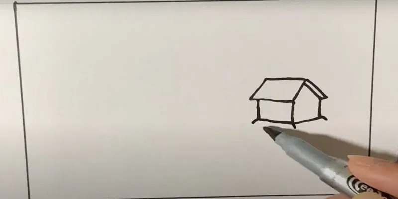 Phác thảo hình dáng ngôi nhà đơn giản ở góc phải giấy vẽ