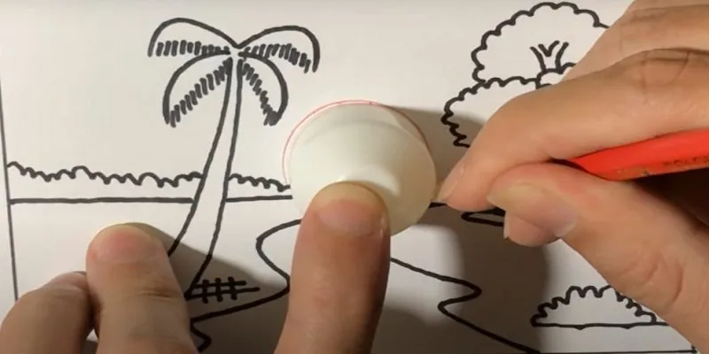 Sử dụng vật tròn để vẽ mặt trời mọc sau rặng cây xa xăm